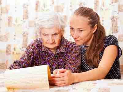 Young doctor holds the old woman's hand
