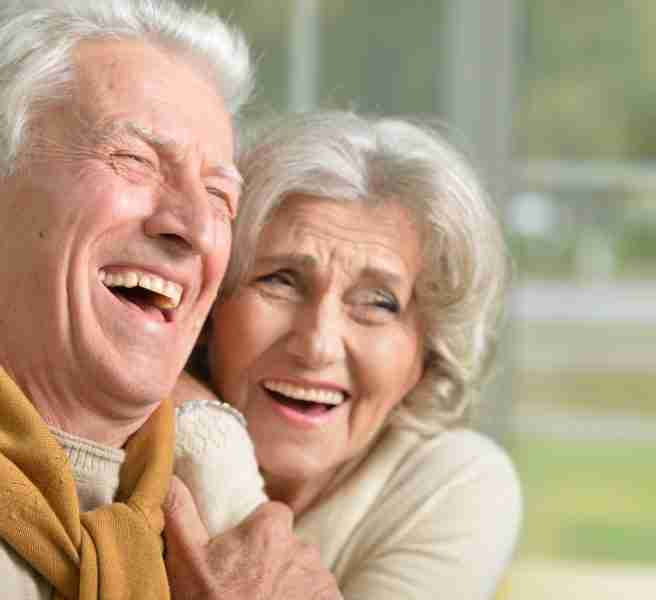 portrait of a happy laughing senior couple at home