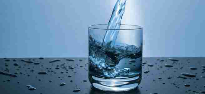 pouring water into glass