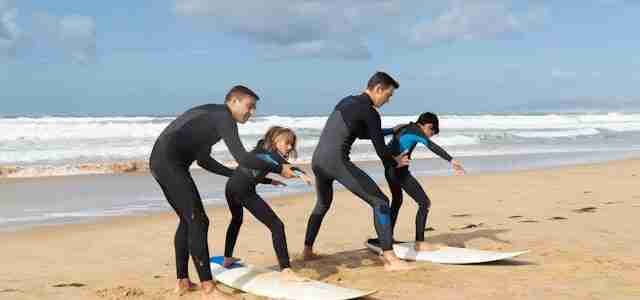 family surfing in hawaii