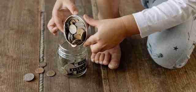 child counting money in jar cost of raising a large family