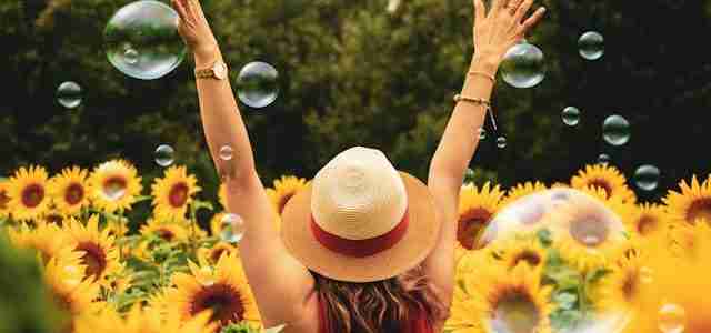 confident woman in field of sunflowers