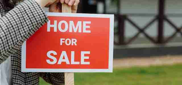 home for sale sign on post