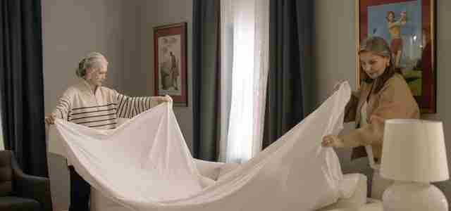 two women folding sheets
