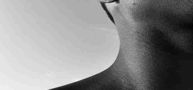 black and white photo of neck and ear of person for hearing loss